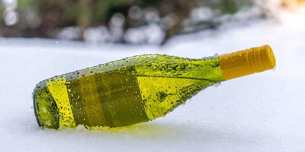 Wine bottle laying in snow