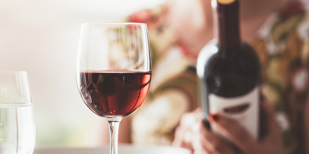 Woman reading a wine bottle's label