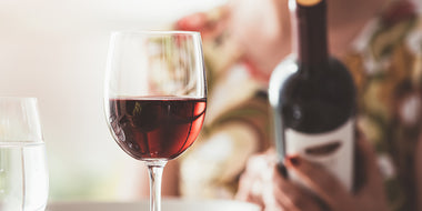 Woman reading a wine bottle's label