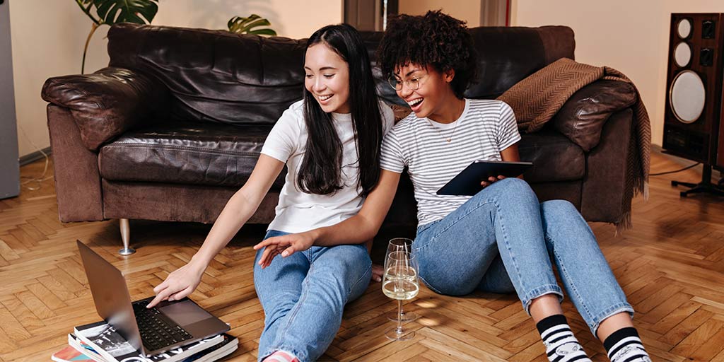 Two young ladies taking a virtual wine tasting pop quiz