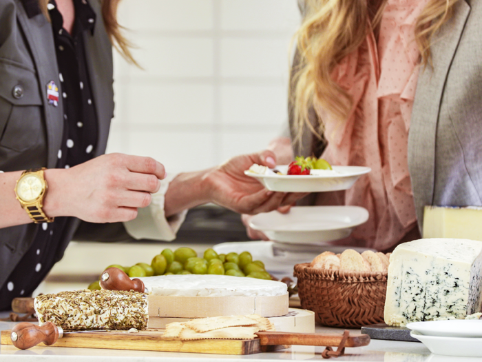 Putting together plates of cheese and fruit