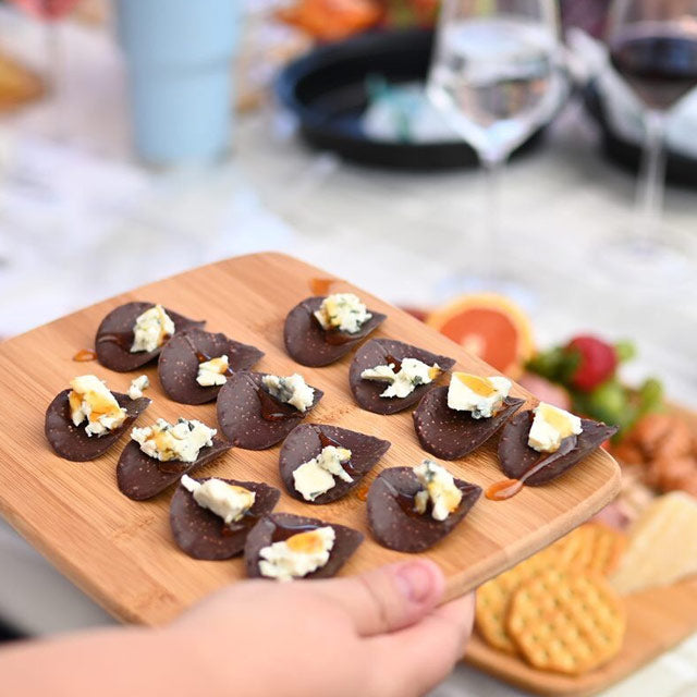 Tray of wine nachos - chocolate crisps with blue cheese and honey