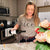 Woman pouring wine in kitchen