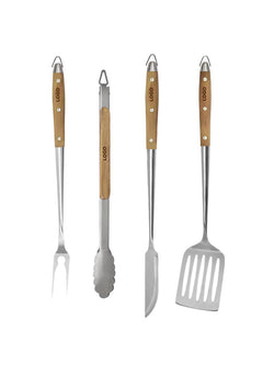 Four stainless steel outdoor grilling tools with light wood handles, including a fork, tongs, skewer knife, and spatula, arranged side by side on a white background.