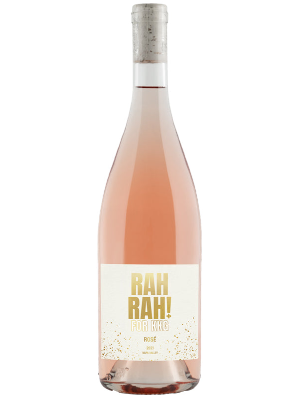 A bottle of Rosé wine with a pale pink liquid, featuring a white label with gold glitter and the text 'RAH RAH! FOR KING' in gold, topped with a cork, on a white background.