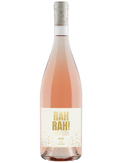 A bottle of Rosé wine with a pale pink liquid, featuring a white label with gold glitter and the text 'RAH RAH! FOR KING' in gold, topped with a cork, on a white background.
