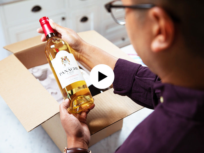 Man opening Wine Club box