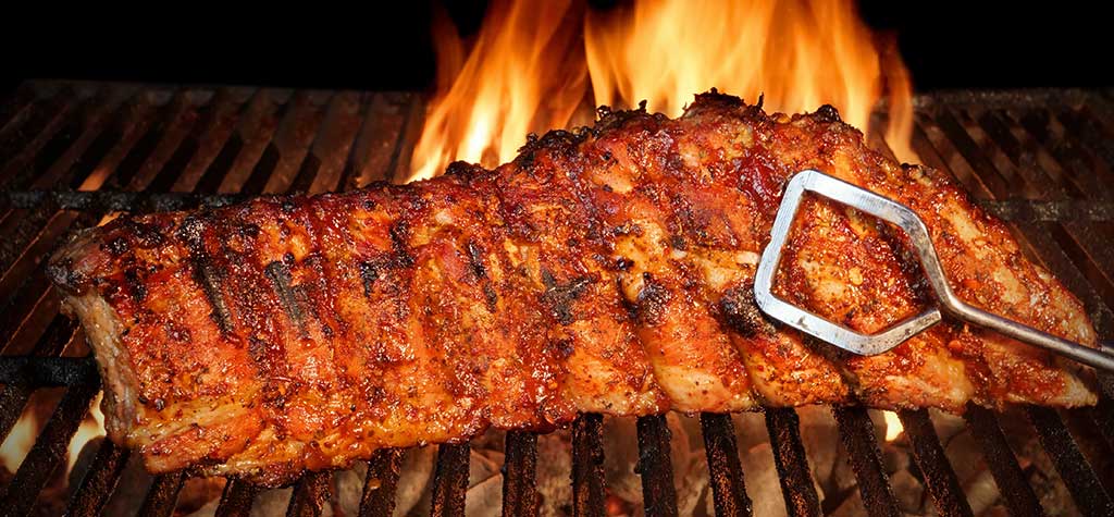 Ribs grilling on a charcoal grill