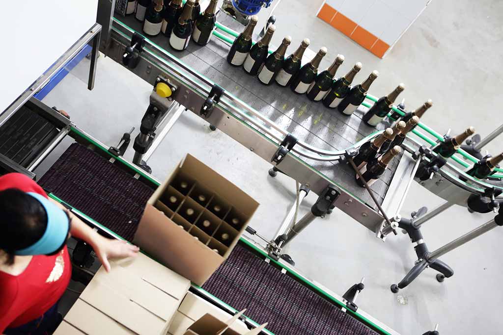 Winery worker packing bottles