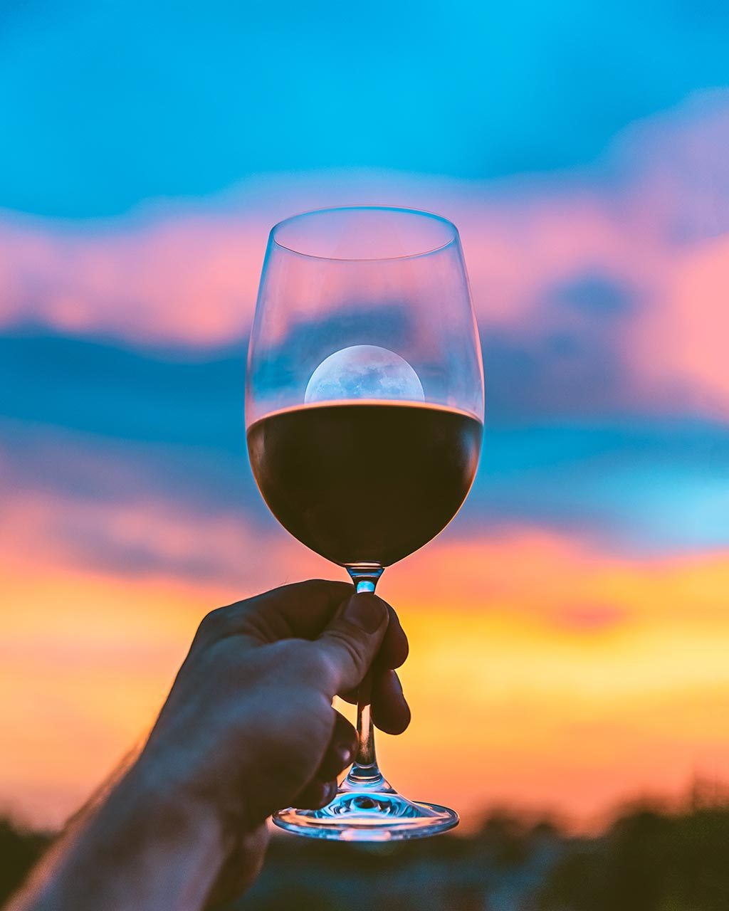 Crowd-Pleasing Tasting Themes - wine glass with moon and sunset behind it