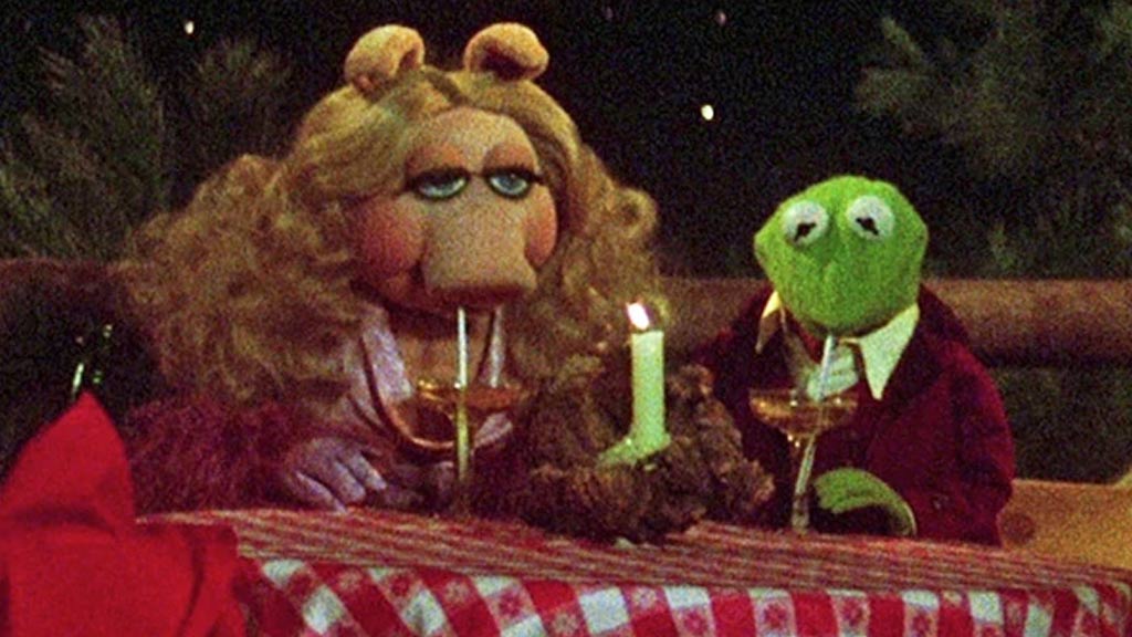 Miss Piggy and Kermit having a romantic dinner with wine in The Muppet Movie