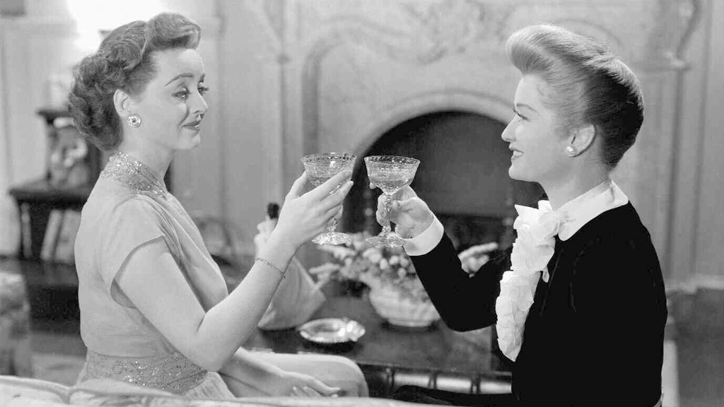 Bette Davis and Miriam Hopkins cheering in Old Acquaintance