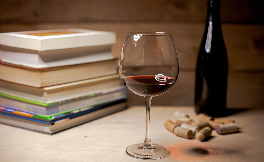 Books with a glass of wine