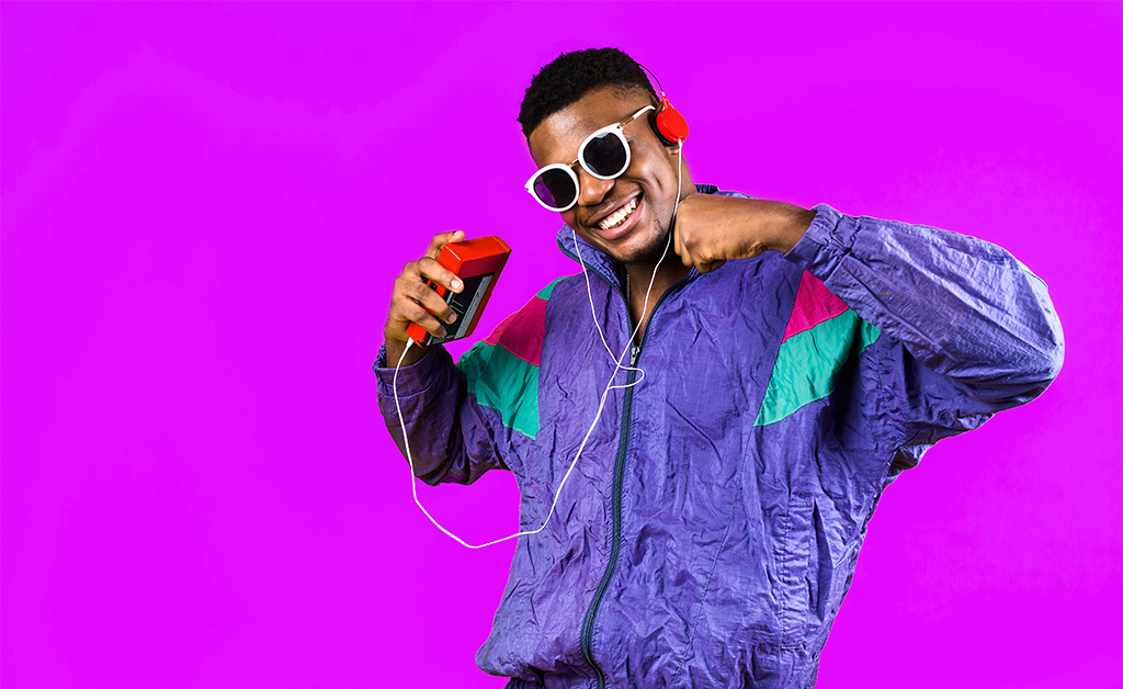 Young man, in a jacket in the style of the 90s, with a retro cassette player, hears music, the mood of dancing and fun, yellow and purple colors.